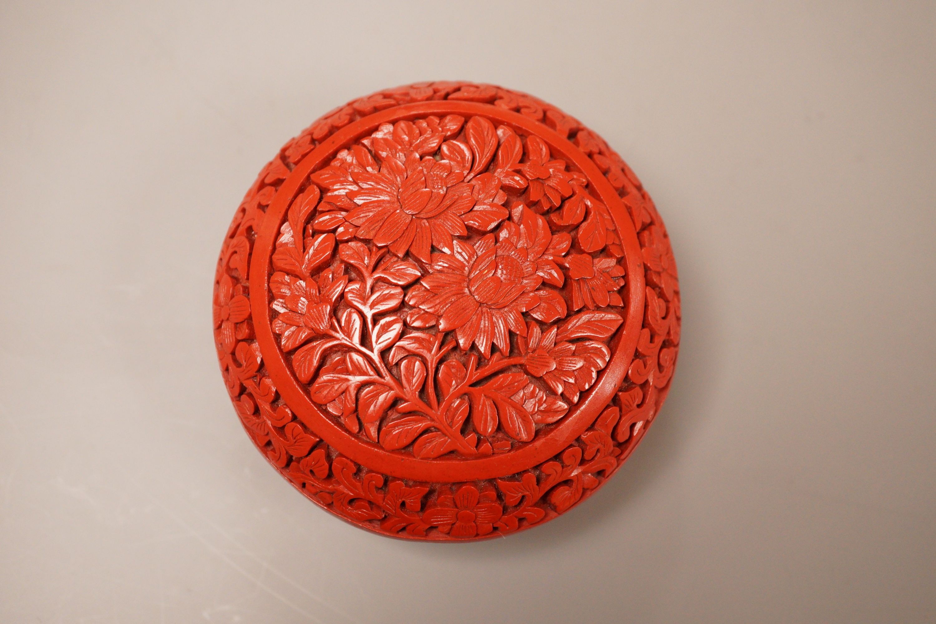 A Chinese cinnabar lacquer box, 8cm diameter